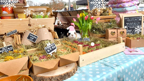 Guinea pig supplies market stall with hay cookies , forages and hay.